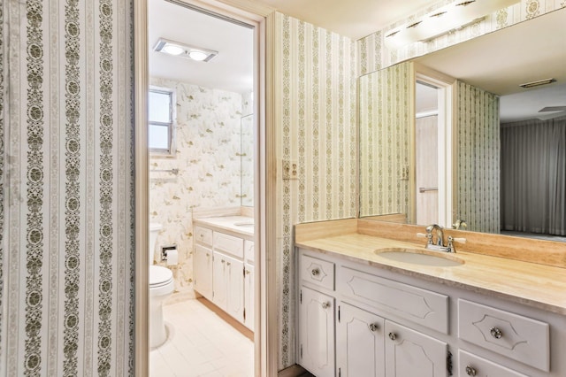 bathroom with tile floors, large vanity, and toilet