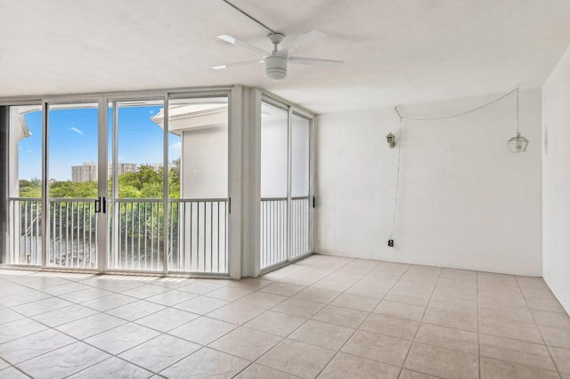 empty room featuring ceiling fan and light tile floors