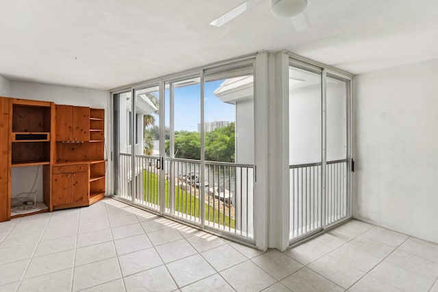 interior space with ceiling fan