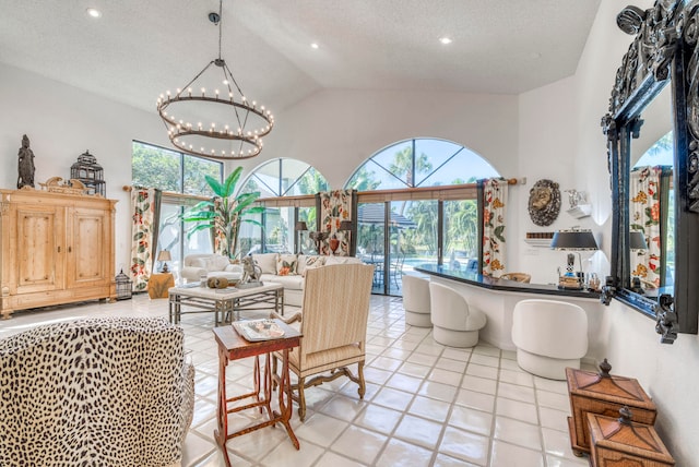 interior space featuring light tile floors, a notable chandelier, a textured ceiling, and a wealth of natural light