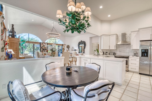 tiled dining area featuring vaulted ceiling and a notable chandelier