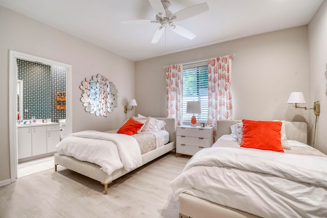 bedroom featuring connected bathroom, ceiling fan, and light hardwood / wood-style flooring