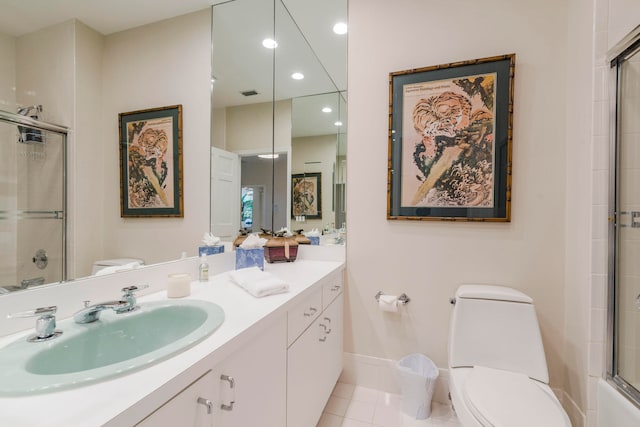 bathroom with tile floors, toilet, and vanity