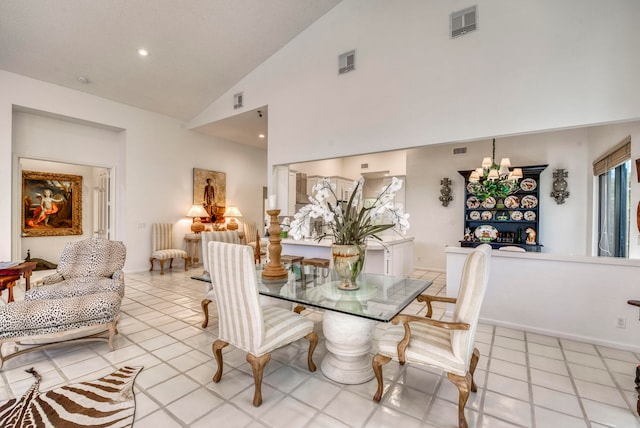 tiled dining space with high vaulted ceiling and a notable chandelier