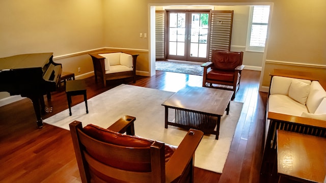 living room featuring french doors and dark wood-type flooring