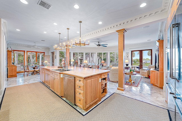 kitchen featuring dishwasher, ceiling fan, decorative columns, and an island with sink