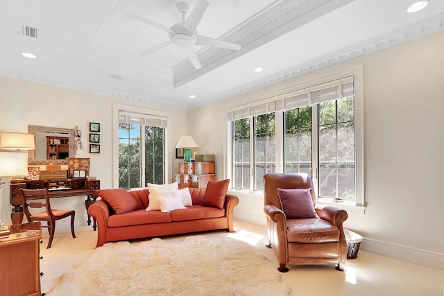 living room with a wealth of natural light, ceiling fan, and light carpet