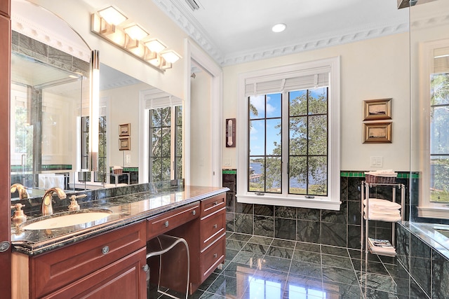 bathroom featuring tile walls, crown molding, tile floors, and vanity