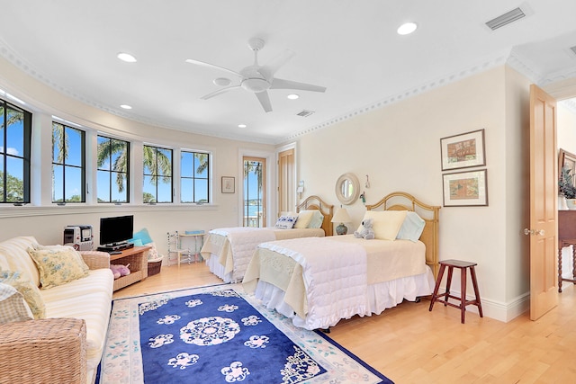 bedroom featuring ornamental molding, light hardwood / wood-style floors, and ceiling fan