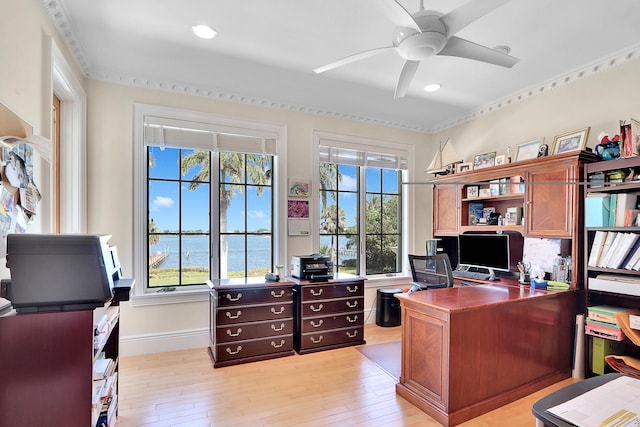 home office featuring a water view, ceiling fan, light hardwood / wood-style floors, and ornamental molding