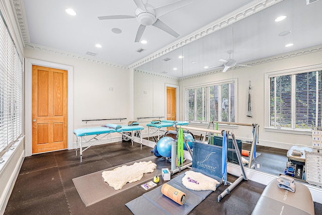 exercise area featuring ceiling fan and ornamental molding