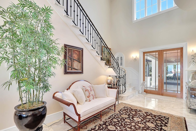 tiled foyer entrance featuring french doors and a high ceiling