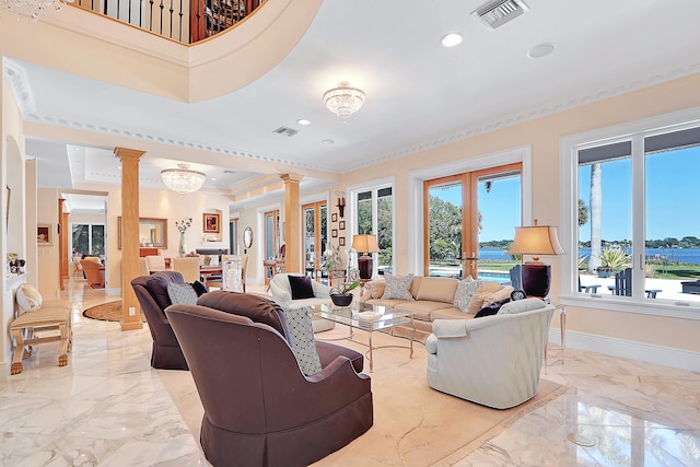 tiled living room with ornamental molding, ornate columns, and a chandelier