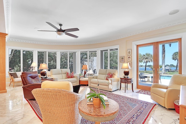 living room featuring ceiling fan, crown molding, and light tile floors