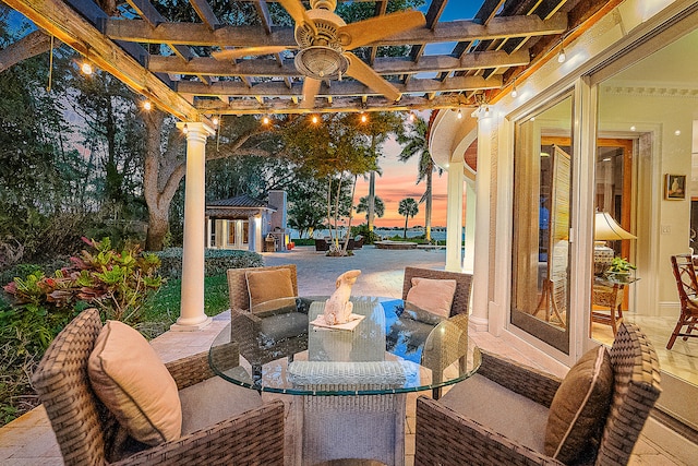 patio terrace at dusk with a pergola and an outdoor hangout area