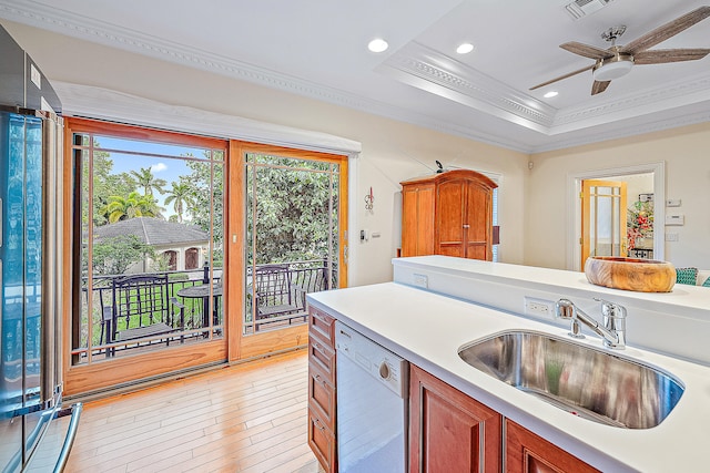 kitchen with plenty of natural light, light hardwood / wood-style floors, dishwasher, and sink