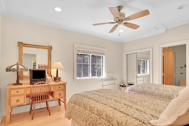 bedroom with ceiling fan, crown molding, and light wood-type flooring