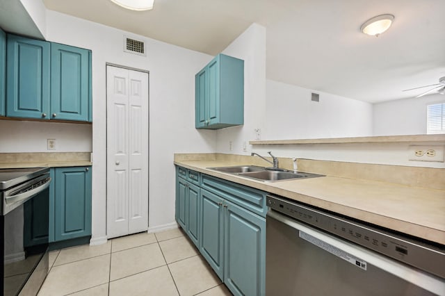 kitchen featuring light tile flooring, blue cabinetry, ceiling fan, stainless steel appliances, and sink