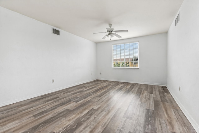 unfurnished room with ceiling fan and dark hardwood / wood-style flooring