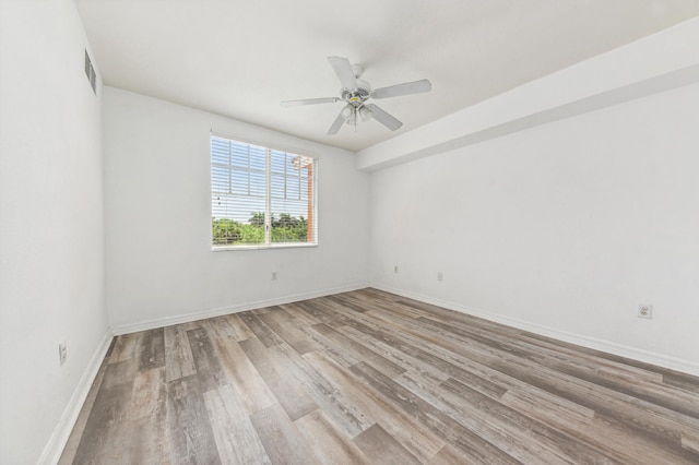 empty room with ceiling fan and light hardwood / wood-style floors