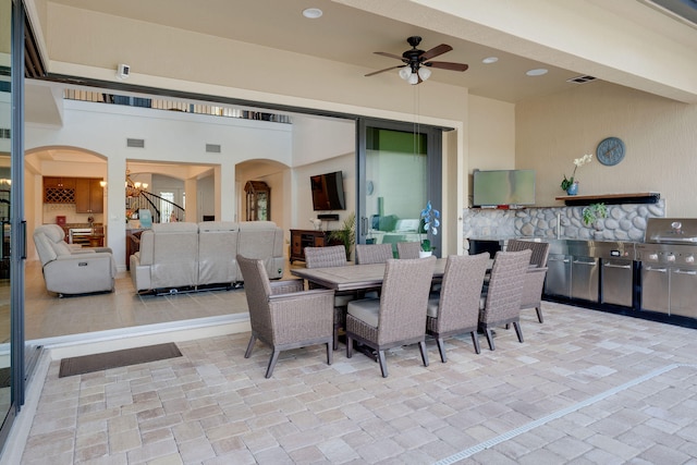 view of patio featuring area for grilling and ceiling fan