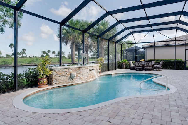 view of pool with glass enclosure, a patio, and pool water feature