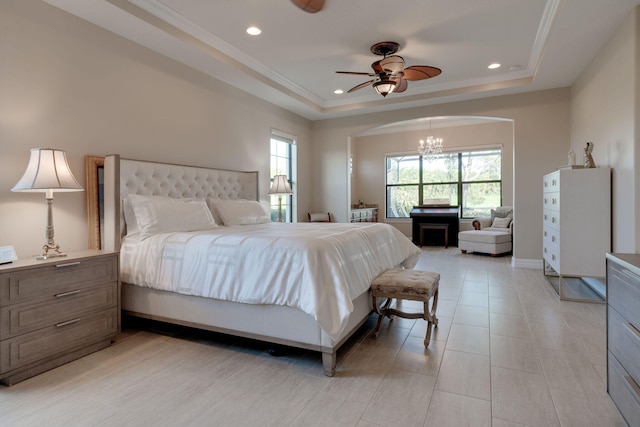 bedroom with ceiling fan with notable chandelier, crown molding, and a tray ceiling