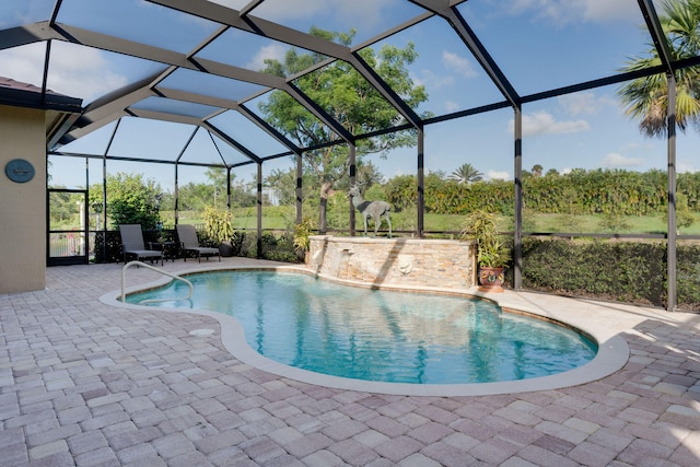 view of swimming pool featuring a patio and glass enclosure