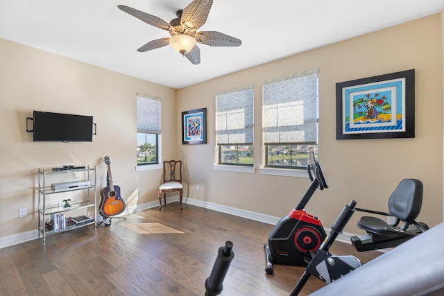 workout room featuring dark wood-type flooring and ceiling fan