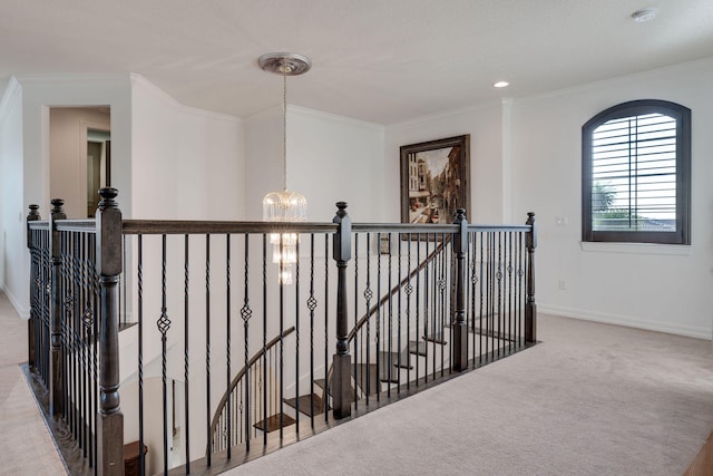 hallway featuring light colored carpet, a chandelier, and crown molding