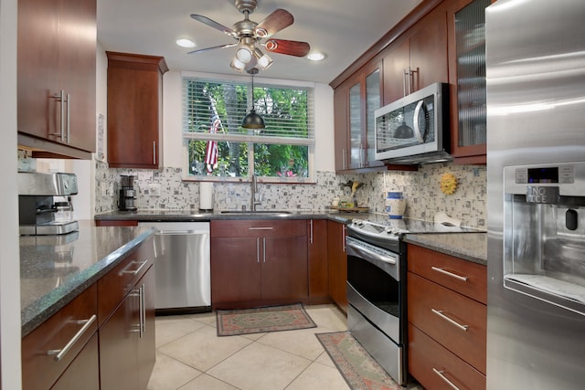 kitchen featuring appliances with stainless steel finishes, tasteful backsplash, ceiling fan, and sink