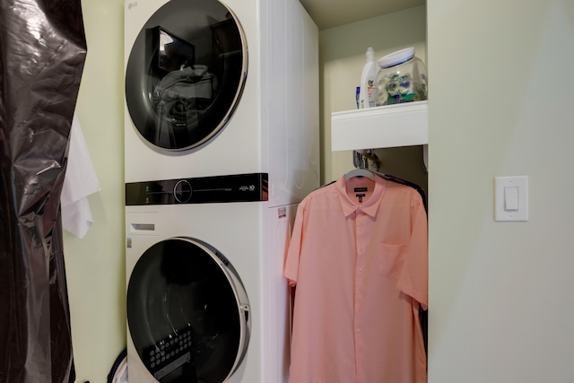 laundry room featuring stacked washer / drying machine