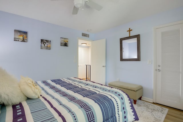 bedroom with a closet, ceiling fan, and light hardwood / wood-style flooring