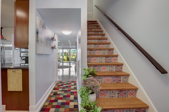 staircase featuring carpet flooring