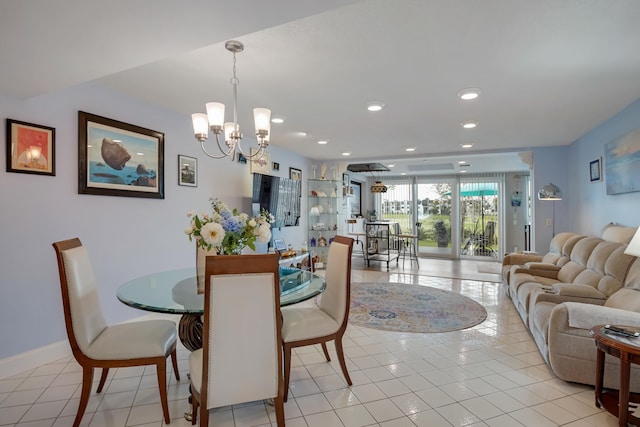 dining space with light tile flooring and a notable chandelier