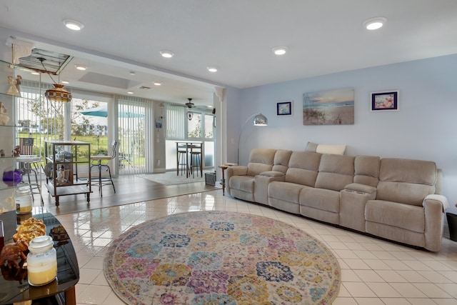 living room featuring light tile flooring and ceiling fan