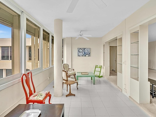 sunroom featuring ceiling fan