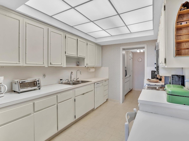 kitchen featuring white cabinetry, sink, light tile floors, and dishwasher