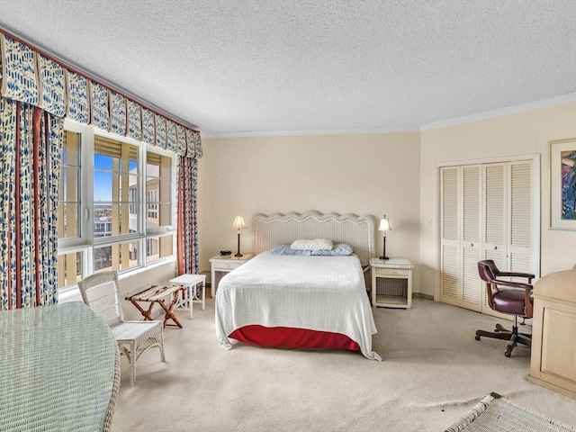 bedroom featuring a closet, ornamental molding, a textured ceiling, and light colored carpet