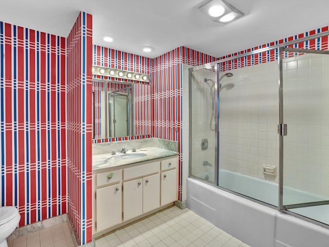 full bathroom featuring vanity, tile floors, shower / bath combination with glass door, and toilet