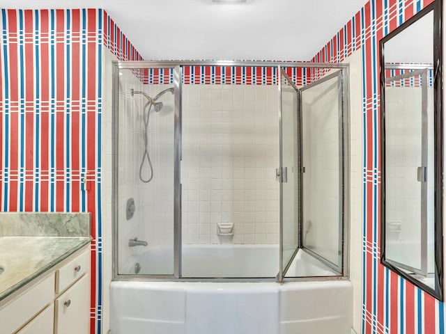 bathroom with vanity and bath / shower combo with glass door