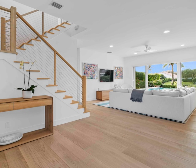 unfurnished living room featuring ceiling fan and light hardwood / wood-style flooring