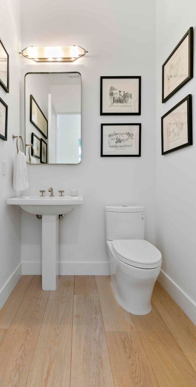 bathroom featuring toilet and hardwood / wood-style floors