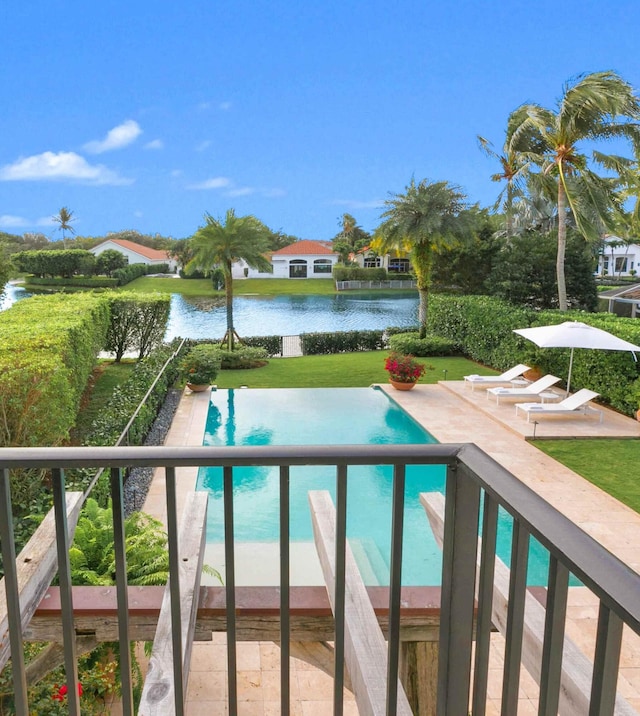 view of swimming pool featuring a patio area and a water view