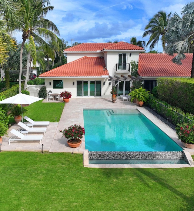 view of swimming pool with a yard and a patio