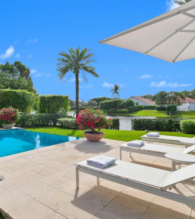 view of swimming pool featuring a yard and a patio area