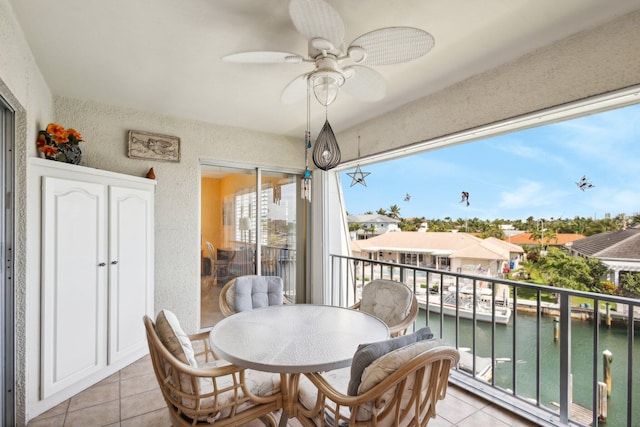 balcony with a water view and ceiling fan