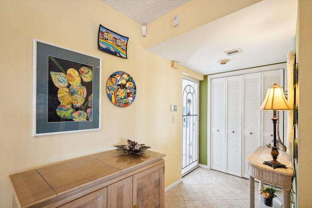 tiled foyer featuring a textured ceiling