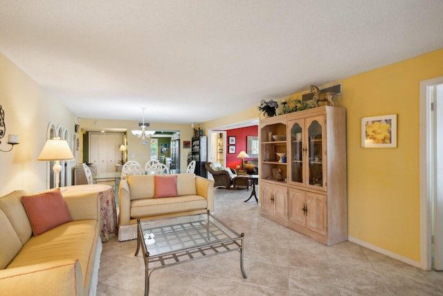 living room featuring light tile patterned floors and a notable chandelier