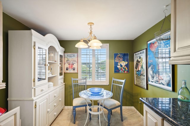 tiled dining space featuring a chandelier